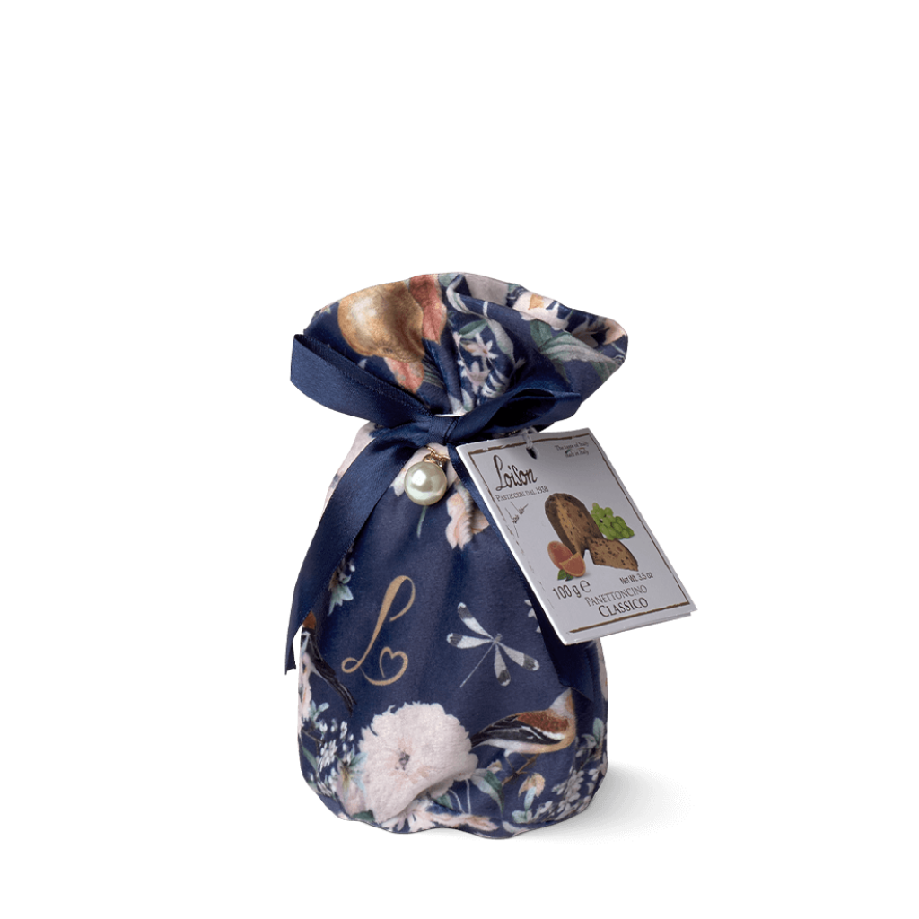 Navy blue gift bag with floral and animal designs, tied with a ribbon, on a white background.