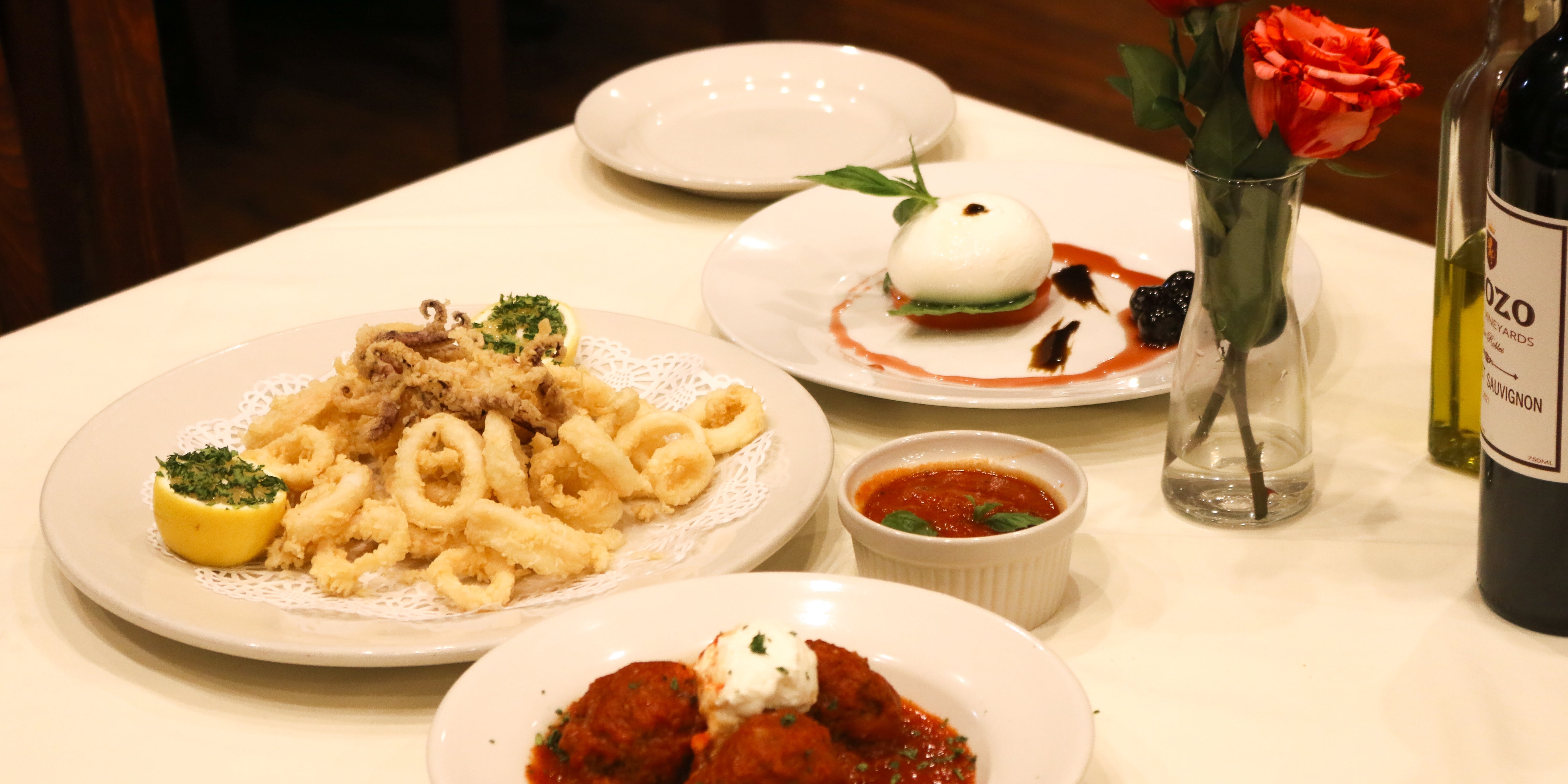 A photo of three of Anacapri's appetizers; fried calamari, meatballs in red sauce, burrata cheese