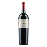 A bottle of CADE Howell Mountain Estate Cabernet Sauvignon with a dark glass body, a cream label reading “CADE,” and a red foil capsule, set against a black background.