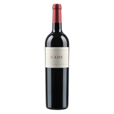 A bottle of CADE Howell Mountain Estate Cabernet Sauvignon with a dark glass body, a cream label reading “CADE,” and a red foil capsule, set against a black background.