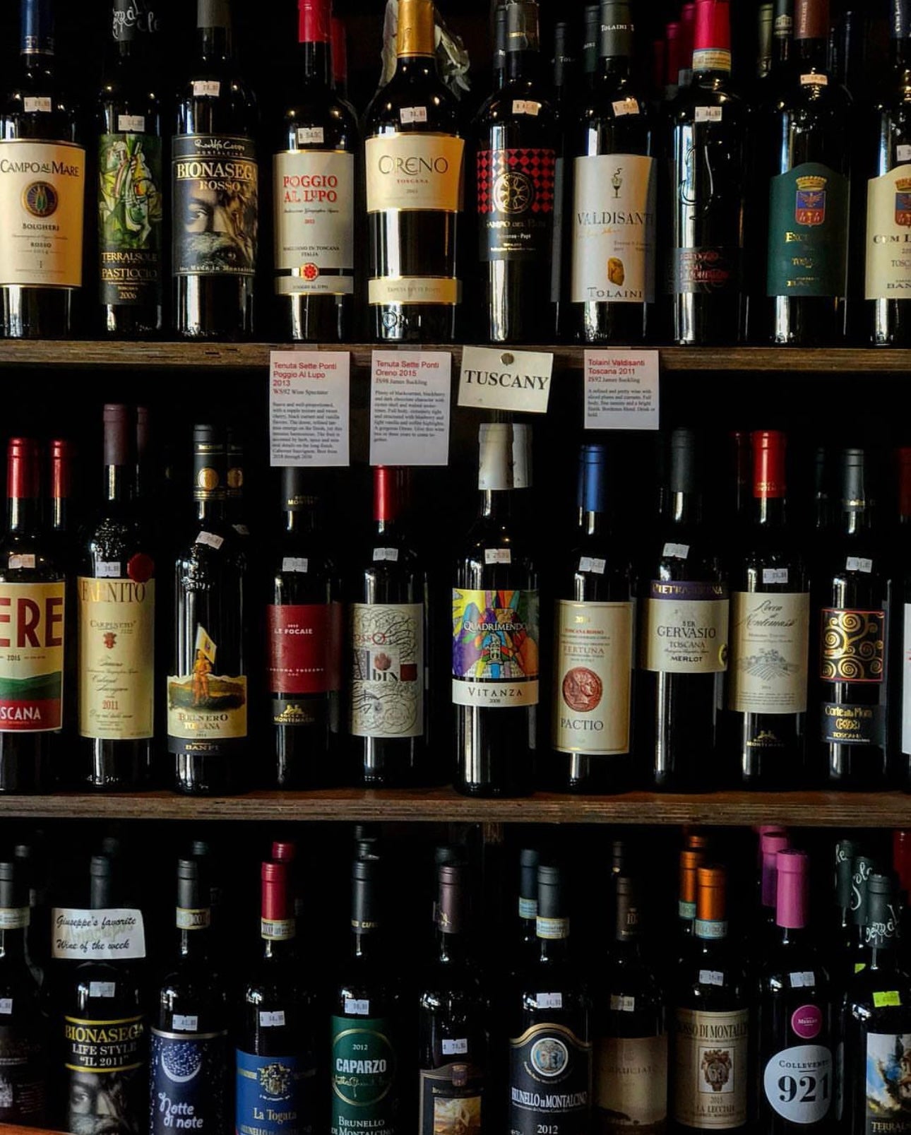 A photo of shelves stocked with different wines all over from all over the world. 