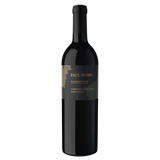A bottle of Paul Hobbs Coombsville Cabernet Sauvignon with a dark glass body and a black label featuring gold lettering, set against a black background.