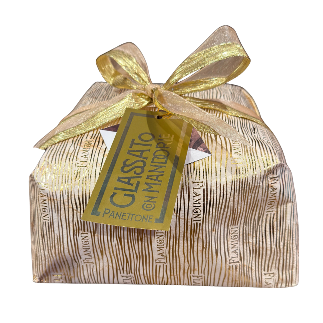 Packaged Panettone with gold ribbon and tag on a white background