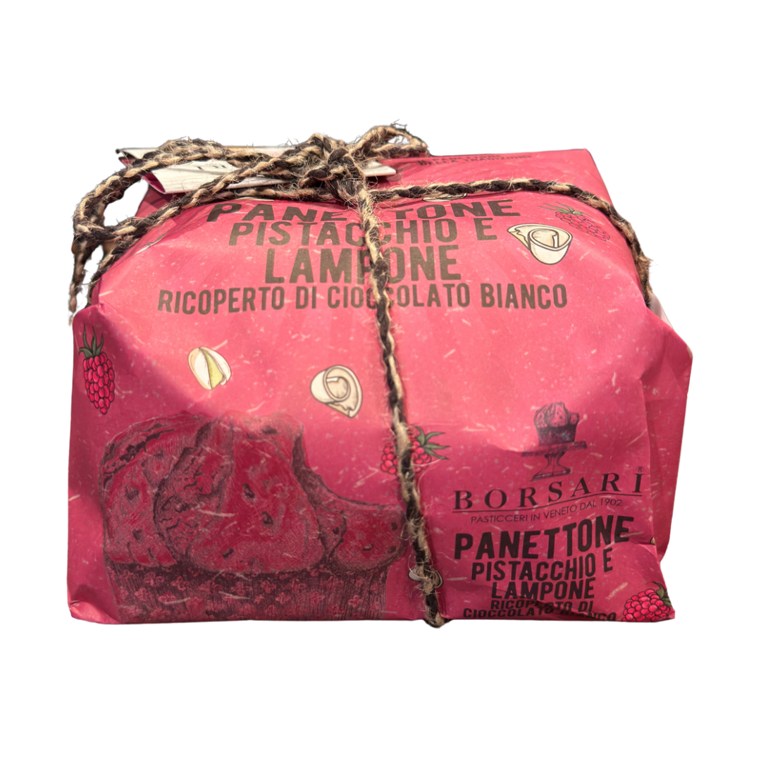 Pink panettone packaging with decorative string on a white background