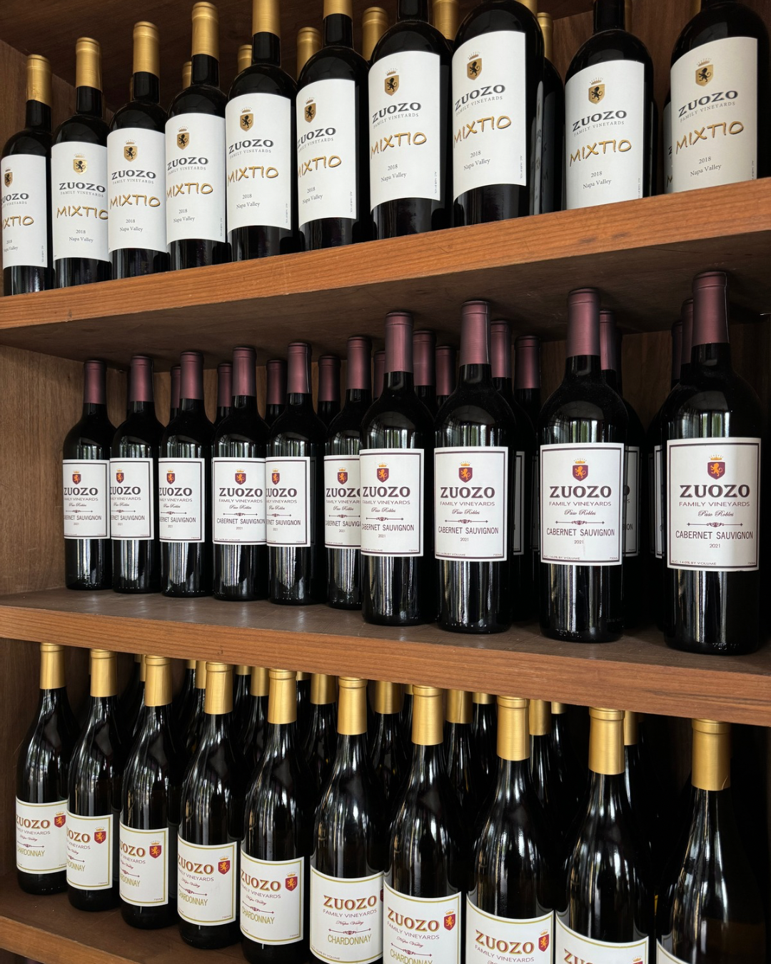 A image of a shelf stocked with three different Zuozo Wine's - Cabernet Sauvignon, Mixto Blend, Chardonnay